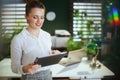 happy elegant business woman in green office using tablet PC Royalty Free Stock Photo