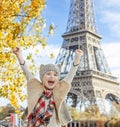 Happy elegant child on embankment in Paris, France rejoicing