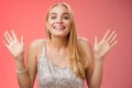 Happy elegant dreamy glamour young blond woman raising hands delight joyfully smiling camera glad see friends comming Royalty Free Stock Photo