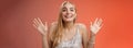 Happy elegant dreamy glamour young blond woman raising hands delight joyfully smiling camera glad see friends comming Royalty Free Stock Photo