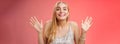 Happy elegant dreamy glamour young blond woman raising hands delight joyfully smiling camera glad see friends comming Royalty Free Stock Photo