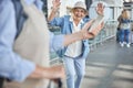 Pleased aged woman staring at a male with a smartphone