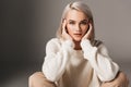 happy elegant girl sitting in white sweater Royalty Free Stock Photo