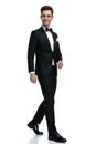 Happy elegant man smiling and walking on white background Royalty Free Stock Photo