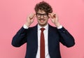 Happy elegant man in suit arranging glasses