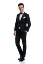 Happy elegant man in tuxedo walking on white background Royalty Free Stock Photo