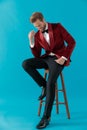 Happy elegant man wearing red velvet tuxedo and smiling Royalty Free Stock Photo