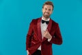 Happy elegant man wearing red velvet tuxedo and smiling Royalty Free Stock Photo