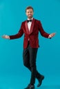 Happy elegant man wearing red velvet tuxedo and welcoming Royalty Free Stock Photo