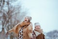 happy elegant mother and daughter catching snow Royalty Free Stock Photo