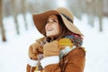 Happy elegant woman outdoors in city park in winter Royalty Free Stock Photo