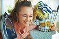 Happy elegant woman with iron and clothes basket Royalty Free Stock Photo