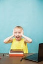 Happy elementary student girl homeschooling on laptop online by internet. Royalty Free Stock Photo