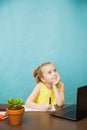 Happy elementary student girl homeschooling on laptop online by internet. Royalty Free Stock Photo