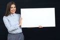 Happy emotional business woman holding white sign board studio p