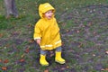 Happy emotional kid enjoing rainy weather in the park