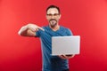 Happy emotional positive man using laptop computer. Royalty Free Stock Photo