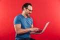 Happy emotional positive man using laptop computer. Royalty Free Stock Photo