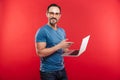 Happy emotional positive man using laptop computer. Royalty Free Stock Photo