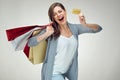 Happy emotional woman holding credit card and shopping bag. Royalty Free Stock Photo