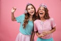 Happy emotional young women friends in princess costumes Royalty Free Stock Photo