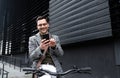 Happy employee environment lover calling colleagues before staff meeting. Cheerful businessman with glasses on reading text Royalty Free Stock Photo