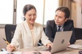 Happy employees discussing potential business Two knowledgeable business people working together with laptops while talking about