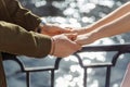 Happy enamored tender couple hugging on the river bank in the city. Romantic engagement of young beautiful people