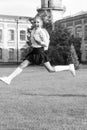 Happy energetic child in uniform with school bag jumping for joy, back to school Royalty Free Stock Photo