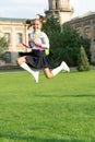 Happy energetic girl child in uniform back to school jumping for joy, September 1 Royalty Free Stock Photo