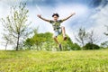 Happy energetic young boy jumping high in the air Royalty Free Stock Photo