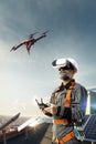 Happy engineer using drone and vr helmet for cheking solar station. in roof Royalty Free Stock Photo