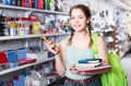 Teenager buying different products in stationery shop