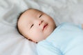 Happy and enjoy Portrait of a newborn Asian baby boy on the bed ,a dummy in his mouth, Charming Royalty Free Stock Photo