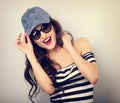 Happy enjoyment young woman in sunglasses and blue baseball cap Royalty Free Stock Photo