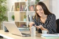 Happy entrepreneur applies sanitizer hand rub at homeoffice