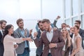 Happy entrepreneur standing in front of his business team Royalty Free Stock Photo