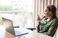 Happy business woman working on line with a laptop and drinking water at office Royalty Free Stock Photo