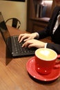 Woman hands working with a laptop in a coffee shop Royalty Free Stock Photo