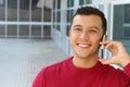 Happy ethnically ambiguous male calling by phone