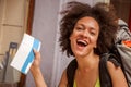 Happy and euphoric backpacker female tourist shows ticket for he Royalty Free Stock Photo
