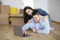 Happy european couple using laptop in new apartment after moving Royalty Free Stock Photo