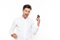 Happy european man with short dark hair screaming while holding Royalty Free Stock Photo