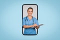 Happy european woman doctor write at clipboard on big smartphone screen, blue background