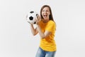 Happy European young woman, football fan or player in yellow uniform holding soccer ball support favorite team isolated Royalty Free Stock Photo