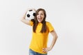 Happy European young woman, football fan or player in yellow uniform holding soccer ball support favorite team isolated Royalty Free Stock Photo