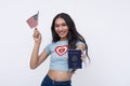 A happy and excited asian trans woman showing off acquired American passport while waving a US flag. Isolated on a white