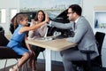 Happy and excited family celebrating just bought a new car from dealership Royalty Free Stock Photo