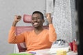 Happy excited businessman celebrate his success. Winner, black man in office reading on laptop, copy space Royalty Free Stock Photo