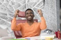 Happy excited businessman celebrate his success. Winner, black man in office reading on laptop, copy space Royalty Free Stock Photo